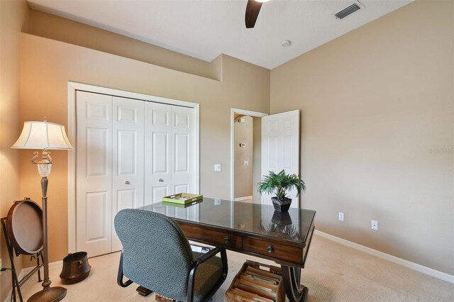 carpeted office featuring ceiling fan