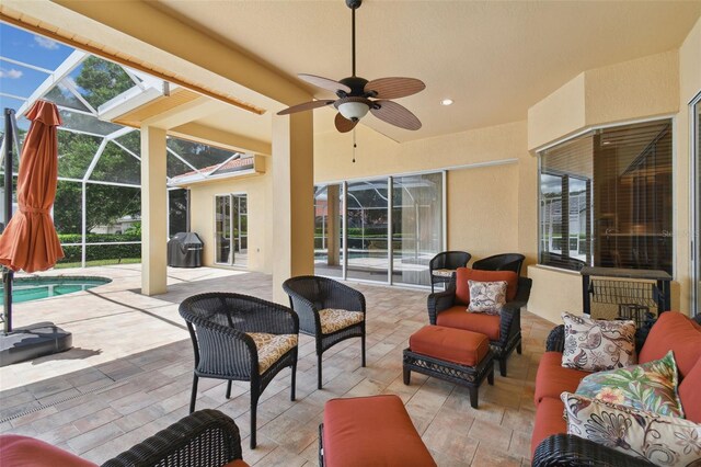 view of patio / terrace with a lanai, ceiling fan, and outdoor lounge area