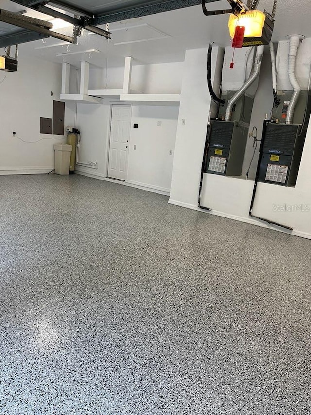 garage featuring electric panel and a garage door opener