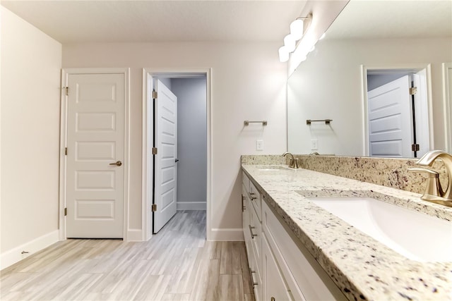 bathroom with hardwood / wood-style floors and vanity