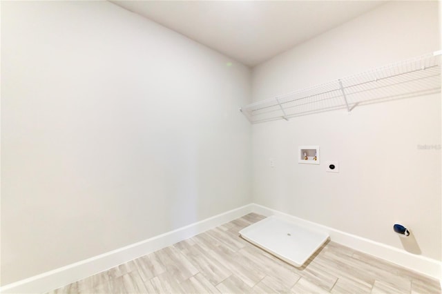 clothes washing area with washer hookup, light wood-type flooring, and electric dryer hookup