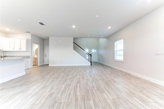 unfurnished living room with light hardwood / wood-style floors