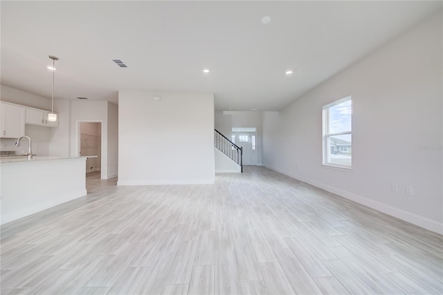 unfurnished living room featuring light hardwood / wood-style flooring