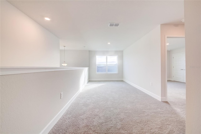 hall featuring light colored carpet