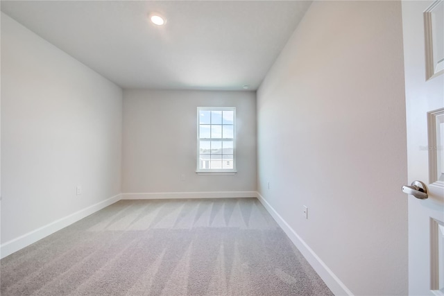 spare room featuring light colored carpet