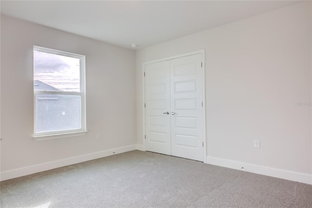 unfurnished bedroom featuring carpet and a closet