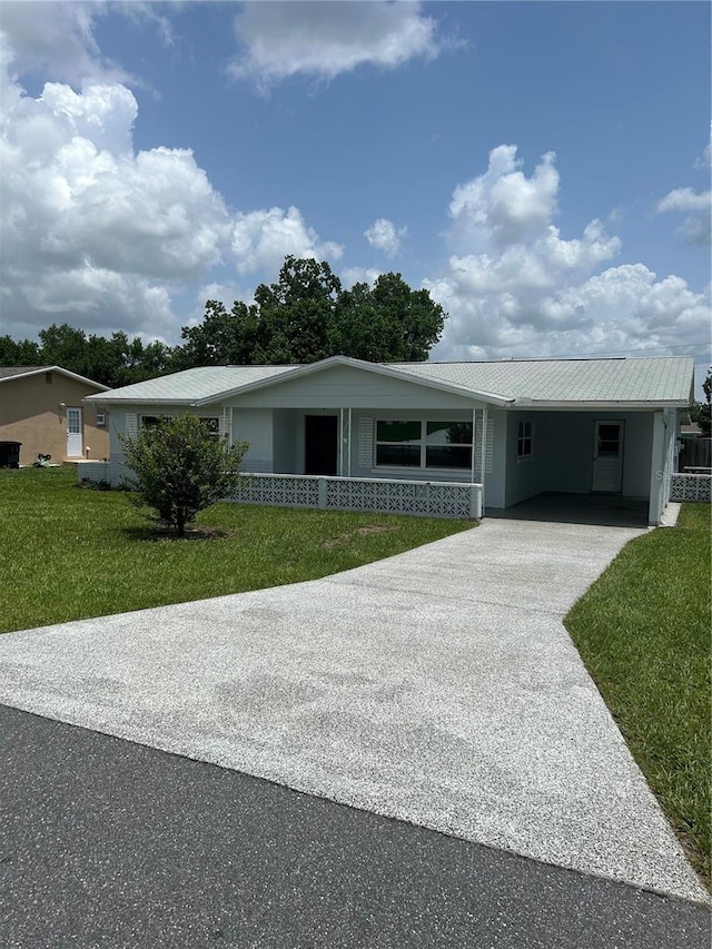 ranch-style house with a carport and a front lawn