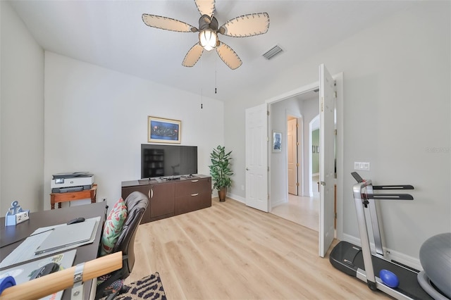 home office with ceiling fan and light hardwood / wood-style floors