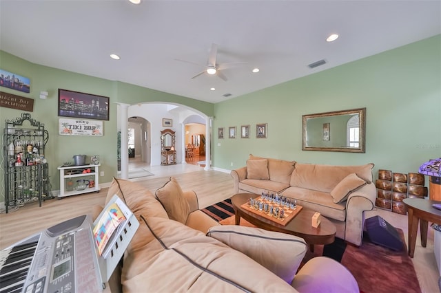 living room featuring hardwood / wood-style flooring and ceiling fan