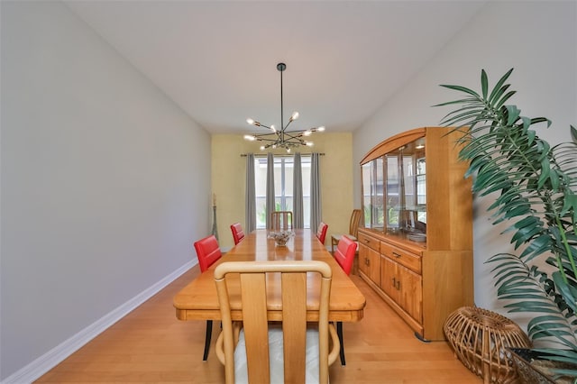 dining area featuring a chandelier and light hardwood / wood-style flooring