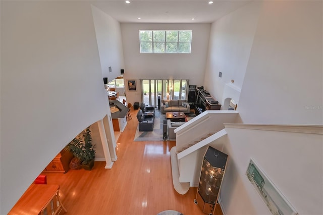 interior space featuring hardwood / wood-style flooring and a towering ceiling