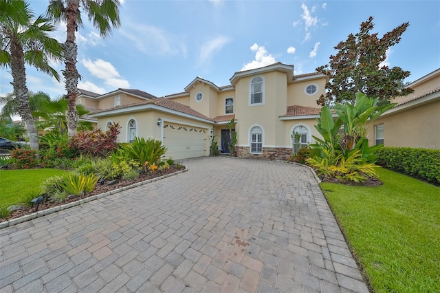 mediterranean / spanish-style house featuring a garage and a front lawn