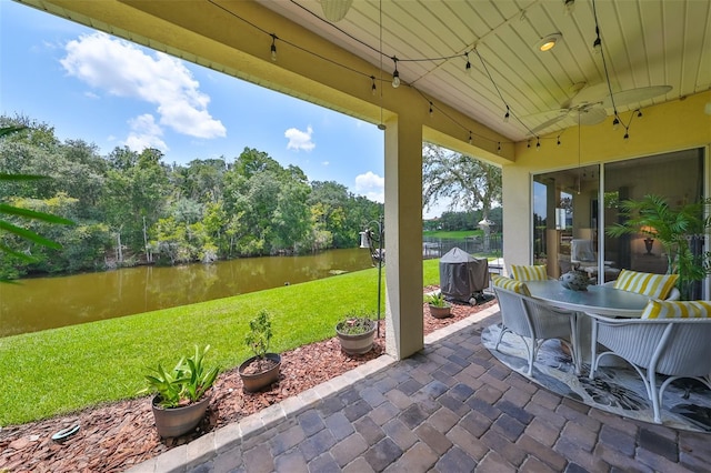 view of patio / terrace with a water view and ceiling fan