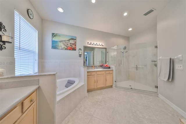 bathroom featuring tile patterned flooring, vanity, and separate shower and tub