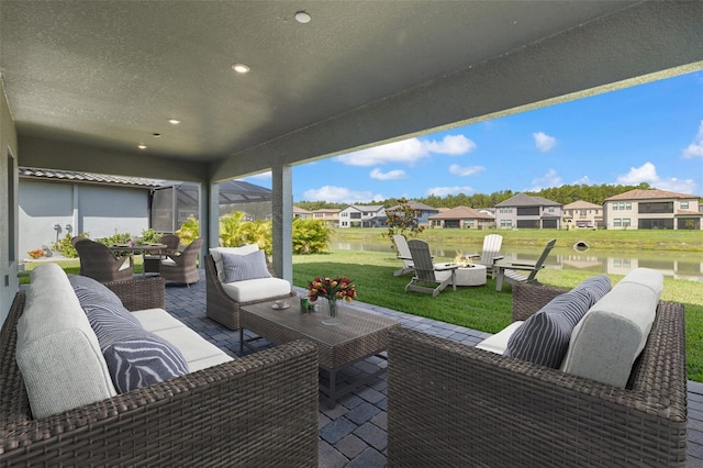 view of patio / terrace featuring a water view and an outdoor living space