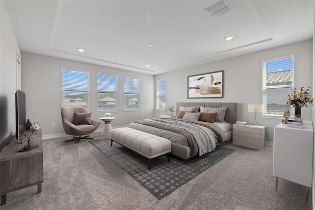 carpeted bedroom featuring multiple windows