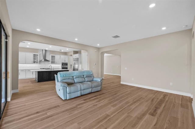 living room featuring light wood-type flooring and sink