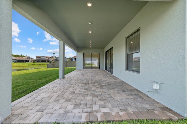 view of patio with a water view