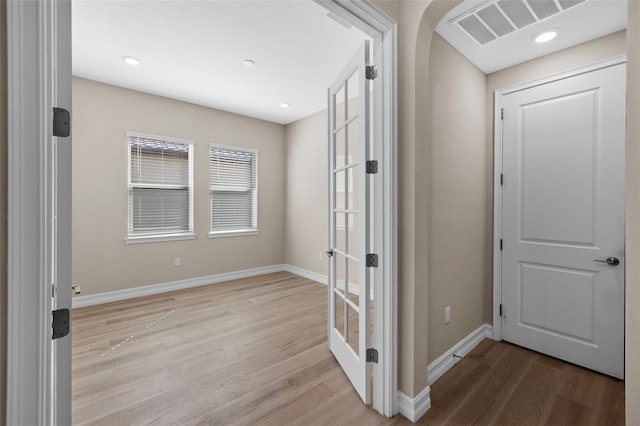 hallway with light hardwood / wood-style flooring