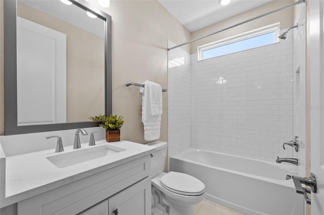 full bathroom with tiled shower / bath, vanity, toilet, and tile patterned floors