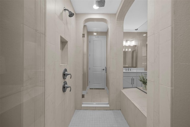 bathroom featuring tile patterned flooring, vanity, and an enclosed shower