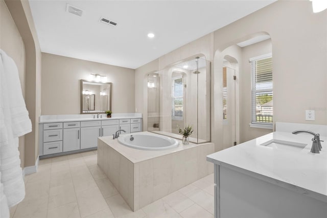 bathroom featuring plus walk in shower and vanity