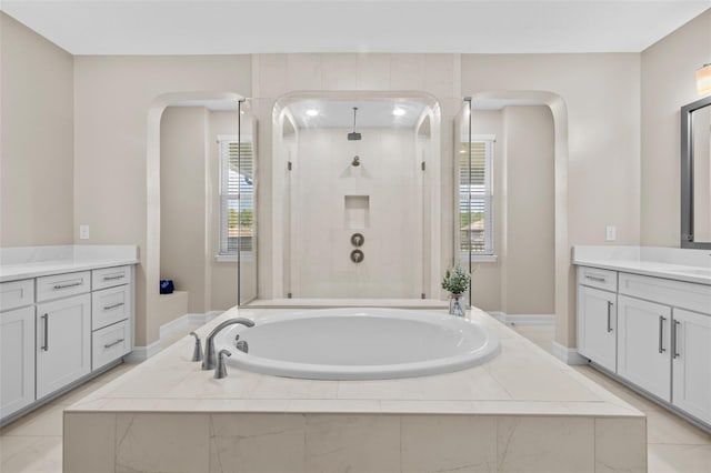 bathroom with plus walk in shower, tile patterned floors, and vanity