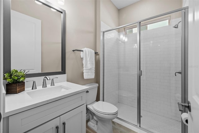 bathroom with a shower with shower door, vanity, toilet, and hardwood / wood-style flooring