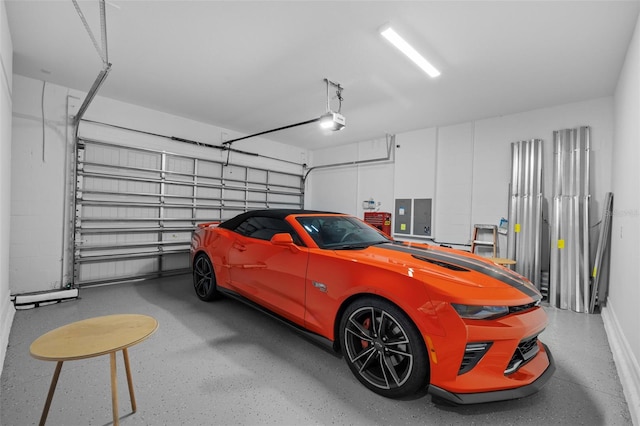 garage with a garage door opener and electric panel