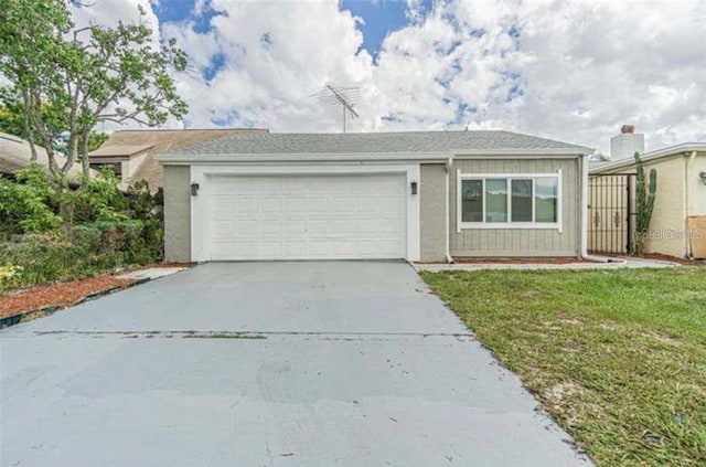 ranch-style home with driveway, a front lawn, and an attached garage