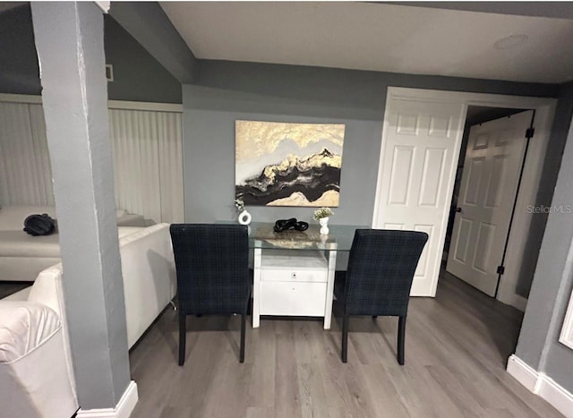 dining space with wood finished floors