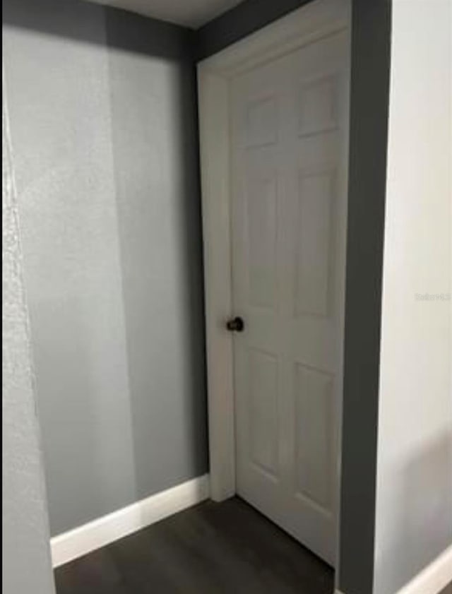 interior space with baseboards and dark wood finished floors