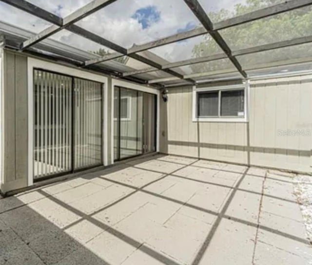 view of patio / terrace featuring a lanai