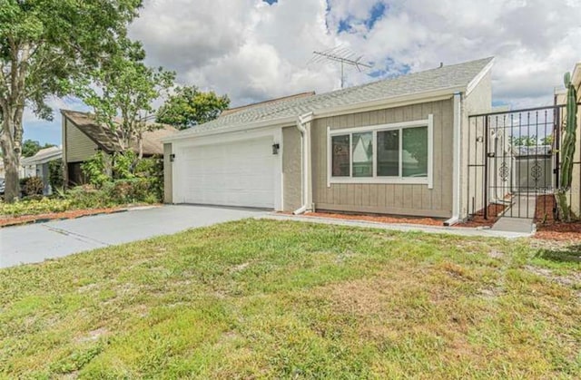 ranch-style home featuring a garage and a front lawn