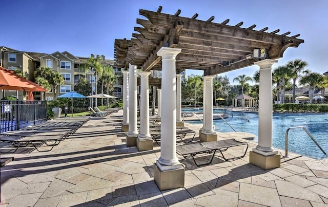 view of patio / terrace featuring a pergola and a community pool