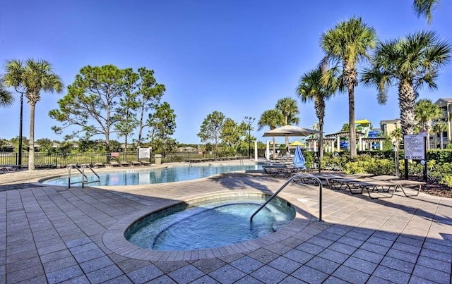 view of swimming pool with a patio and a community hot tub