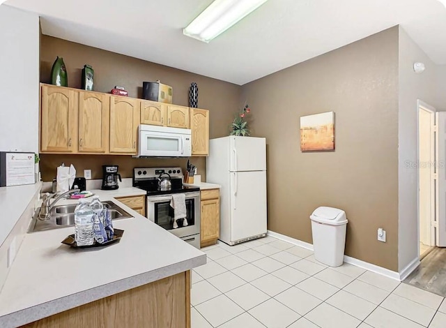 kitchen featuring light brown cabinetry, sink, white appliances, and light hardwood / wood-style floors