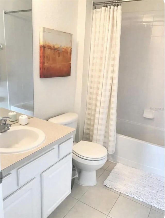 full bathroom featuring vanity, shower / bath combo with shower curtain, toilet, and tile patterned floors