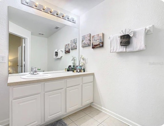 bathroom with tile patterned flooring and vanity