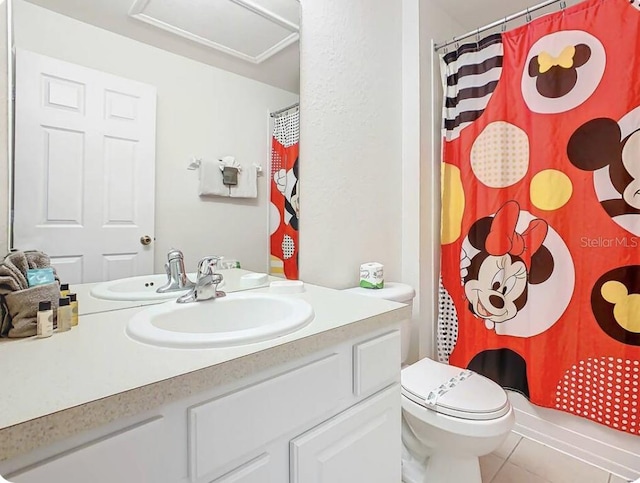 bathroom with tile patterned flooring, toilet, and vanity