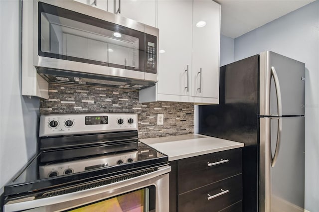 kitchen featuring tasteful backsplash, appliances with stainless steel finishes, and white cabinets