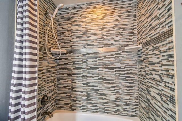 bathroom with shower / bath combination with curtain