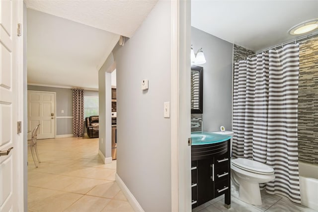 full bathroom featuring toilet, ornamental molding, vanity, shower / bath combo, and tile patterned flooring