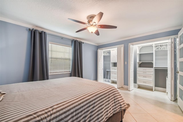 bedroom featuring ornamental molding, light tile patterned floors, a textured ceiling, and ceiling fan