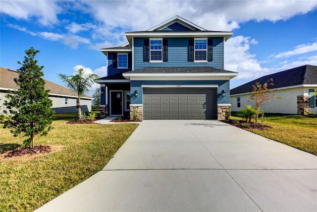 view of front of home featuring a front yard and a garage