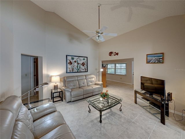 tiled living room with ceiling fan, a textured ceiling, and high vaulted ceiling