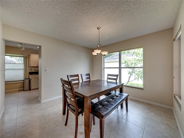 dining room featuring light tile patterned floors and a textured ceiling