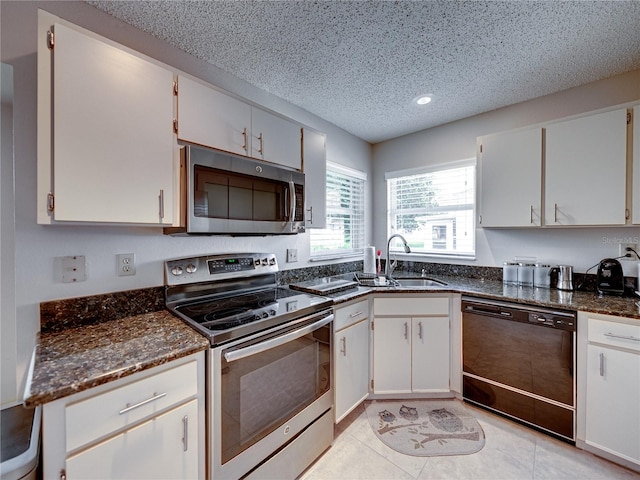 kitchen featuring sink, white cabinets, and appliances with stainless steel finishes