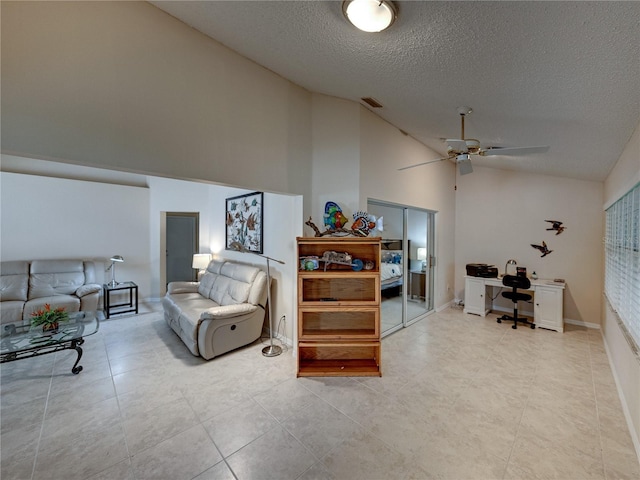 living room with ceiling fan, high vaulted ceiling, and a textured ceiling