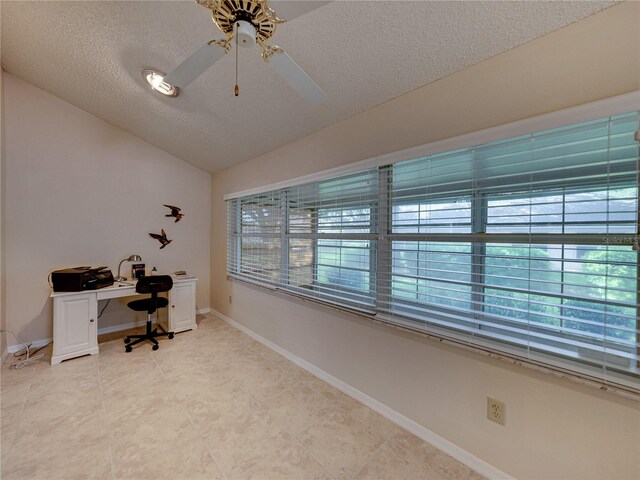 office with a textured ceiling, vaulted ceiling, and ceiling fan